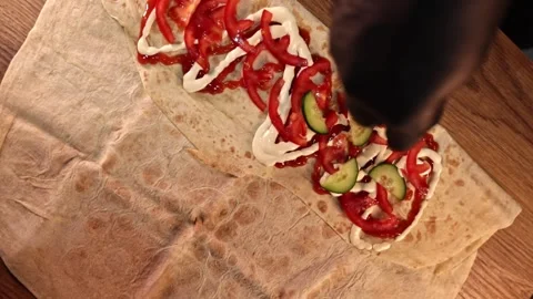 Making Shawarma - Adding Chopped Cucumber Stock Footage 247136285