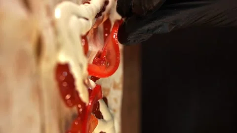 Making Shawarma - Chef Adds Tomatoes to Lavash. Vertical Video Stock Footage 247142065