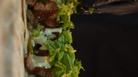 Making Shawarma - Placing Grilled Meat and Vegetables on Lettuce Leaves Stock Footage 247142323