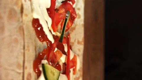Making Shawarma - Sliced Cucumbers Falling onto Lavash. Vertical Video Stock Footage 247142095