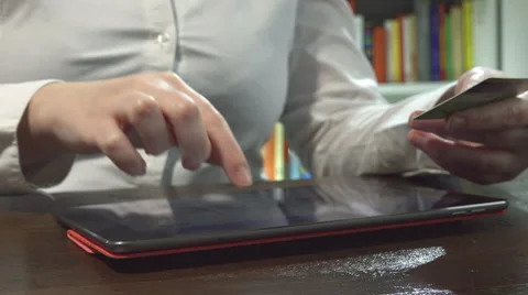 Making shopping on line using credit card and tablet computer at home Stock Footage 60575971