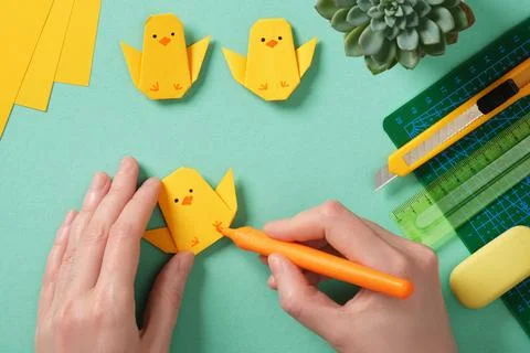 Making a simple Easter origami handicraft. Draw eyes and legs on the finish.. Stock Photos