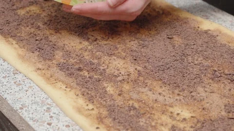 Making sinnabon buns. Sprinkle with sugar, cinnamon and grated chocolate. Stock Footage 166501849
