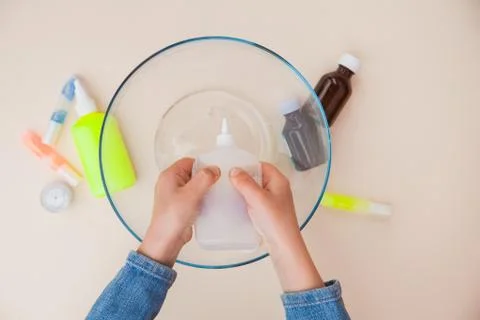 Making slime, step by step instruction, step one, adding stationery glue. Stock Photos
