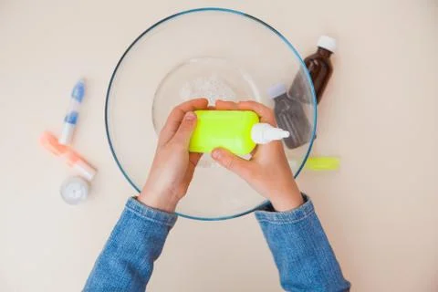 Making slime, step by step instruction, step five, adding thickening agent Stock Photos
