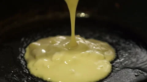 Making Small Pancake on Sizzling Frying Pan Video stock 61317850