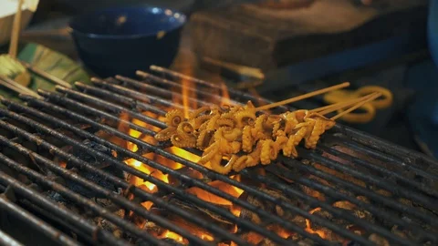 Making small squid on a grill Stock Footage 93713625