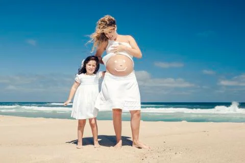 Making a smile on mom's belly Stock Photos