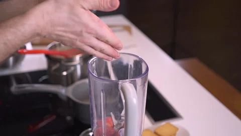 Making Smoothie in Blender. Hand throws blueberries in a blender. 動画素材 143415456