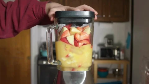Making a Smoothie Drink in Kitchen In Slow Motion with Blender and Fruits Stock Footage 125309535