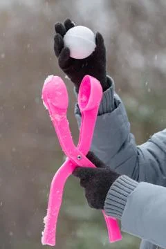 Making a snowball using a plastic mold Stock Photos