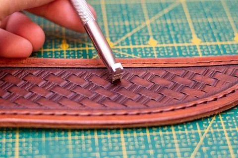 Making stamping on leather with handtools Stock Photos