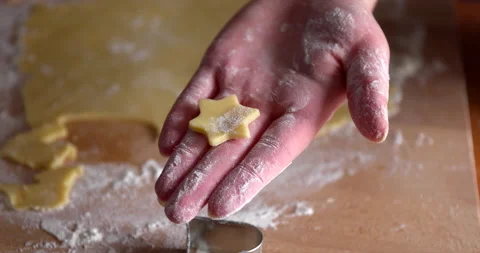 Making star shape cookies from a dough with a cookie cutter tool Stock Footage 151636012