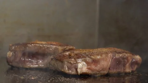 Making steak on a hot plate Stock Footage 127124066