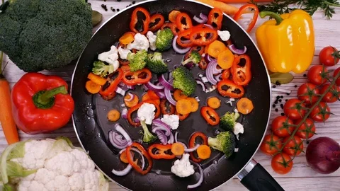 Making stir fried vegetables, ingredients fall into the frying pan Video stock 102298008