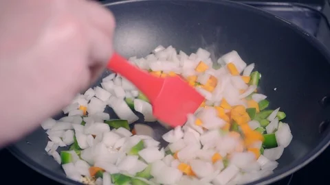 Making stir fry vegetables using wok in home kitchen Stock Footage 118047101