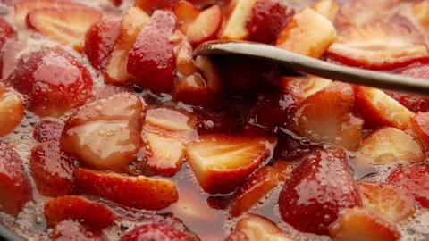 Making strawberry jam in its own juice with the addition of sugar in an open Stock Footage 241333770