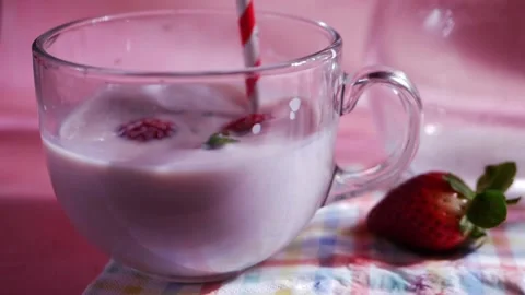Making strawberry milkshake on pink background Stock Footage 171824658