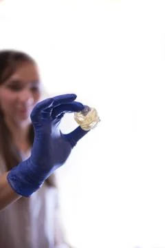 Making sugaring. Close up of depilation master wearing blue. Stock Photos
