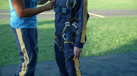 Making sure the lady is ready for her first sky diving experience Stock Footage 55338727