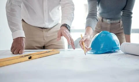 Making sure the plans are up to code. Cropped shot of two unrecognizable Stock Photos