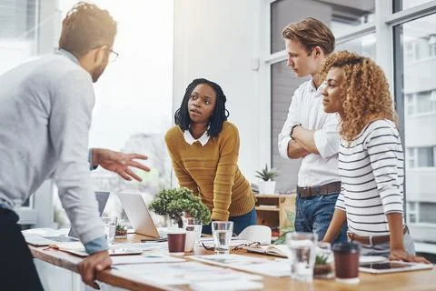 Making sure theyre all on the same page. a group of businesspeople having a Stock Photos
