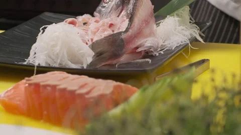 Making sushi with daikon, leaves and cut fish Stock Footage 213468480