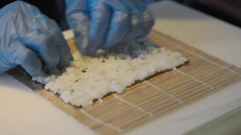Making sushi by hand in a small kitchen in the evening Stock Footage 339381325