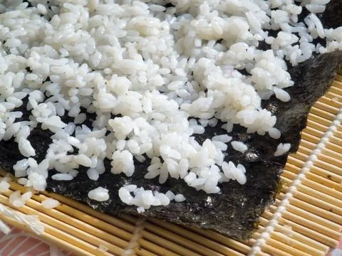 Making sushi. Preparing and making rolls in a restaurant and sushi bar. Stock Photos