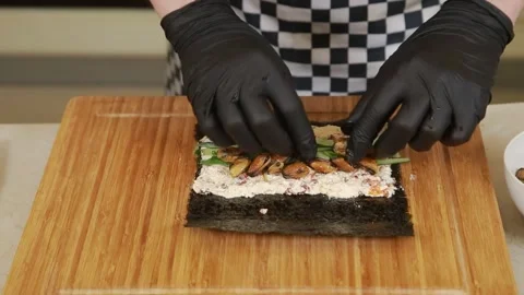 Making sushi roll with fresh vegetables and mussels Stock Footage 340551435