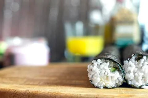 Making Sushi Rolls Workshop. Two Shaped Round Rolls Sealing on a Wooden Board Stock Photos