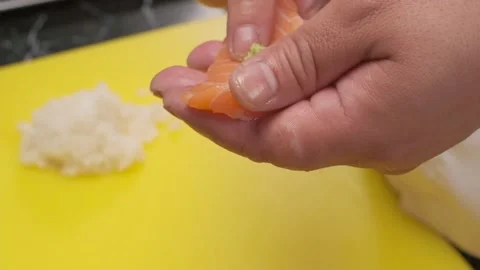 Making sushi with salmon, rice and wasabi Stock Footage 221416443