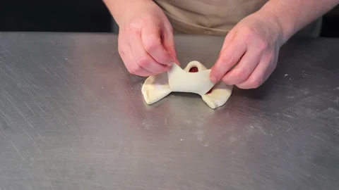 Making sweets from dough and jam filling close-up. Manual work at the bakery Stock Footage 239056307