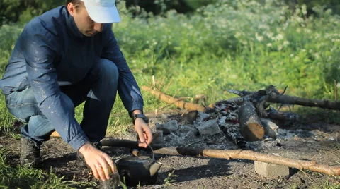 Making tea on campfire Stock Footage 63951292