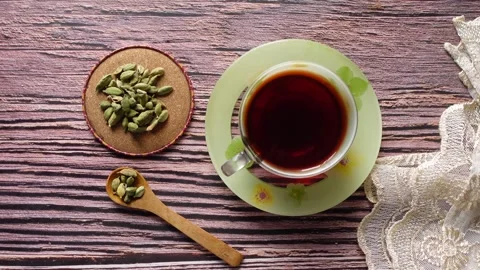 Making tea with cardamom and sitting on wooden table Stock Footage 337125027