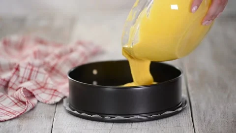 Making tea chiffon Cake. Pouring cake batter into baking tin. Stock Footage 160971251