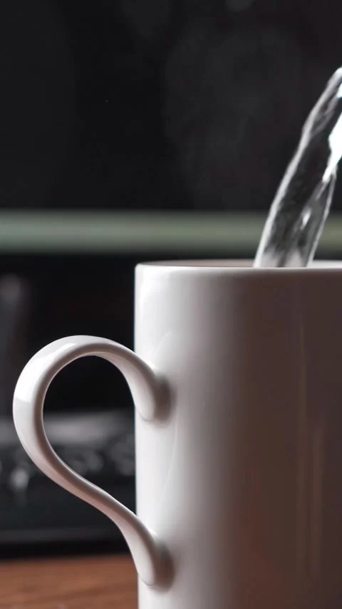 Making tea at computer desk in home office Stock Footage 335915933