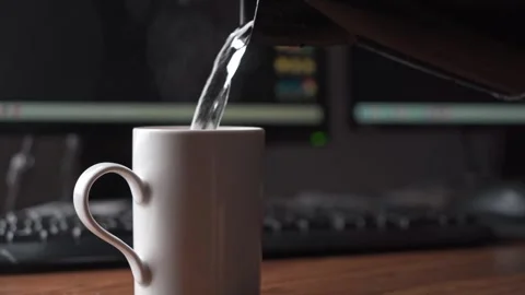 Making tea at computer desk in home office Stock Footage 336269752
