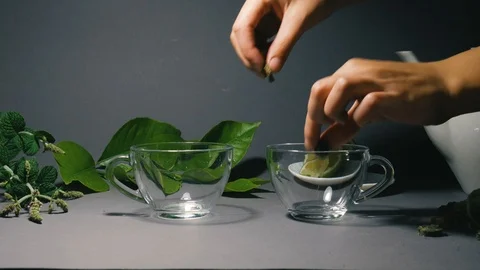 Making tea from herbs in a transparent glass cup Stock Footage 101111359