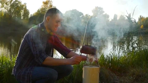 Making tea outdoor on the fire Stock Footage 81768065