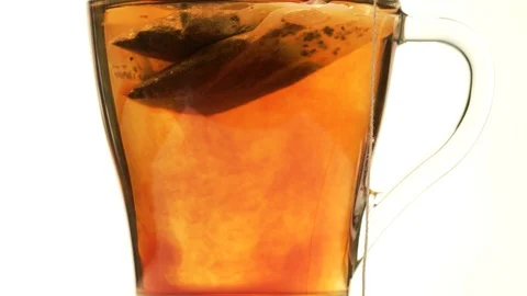 Making tea from a tea bag close up on a light background Stock Footage 98743701