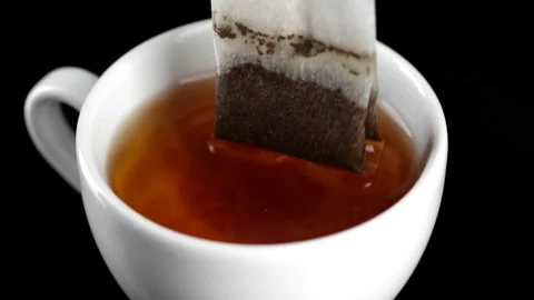 Making tea with tea bag in white cap, close up Видео 166215808
