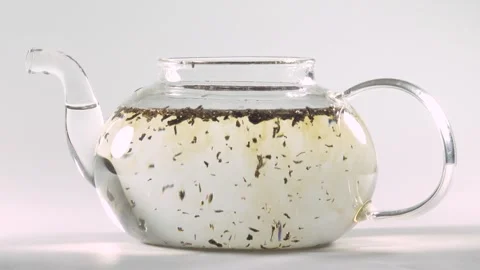 Making tea in the transparent glass tea pot Stock Footage 252668795