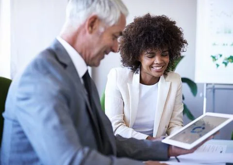Making their partnership work. two business associates working together. Stock Photos