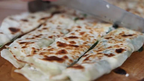 Making thin bread with fillings in a kitchen setting Stock Footage 331261973