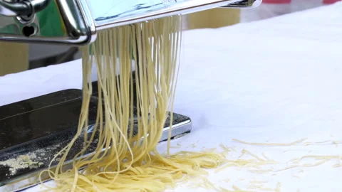 Making thin noodles for soup with rolling machine from special homemade dough Stock Footage 145778271