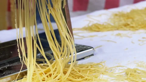 Making thin noodles for soup with rolling machine from special homemade dough Stock Footage 150668647