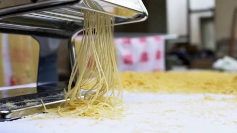 Making thin noodles for soup with rolling machine from special homemade dough Stock Footage 156136706