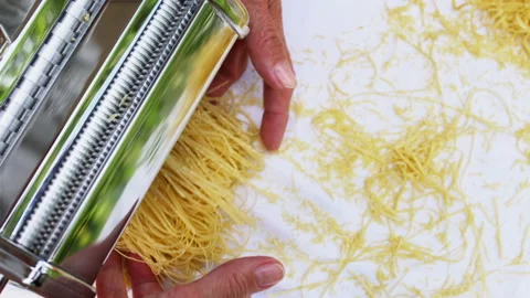 Making thin noodles for soup with rolling machine from special homemade dough Stock Footage 156136997