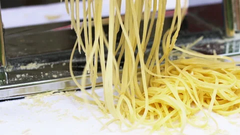 Making thin noodles for soup with rolling machine from special homemade dough Stock Footage 218131376